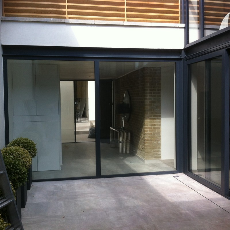 Floor-to-ceiling sliding doors opening to courtyard in Herne Hill