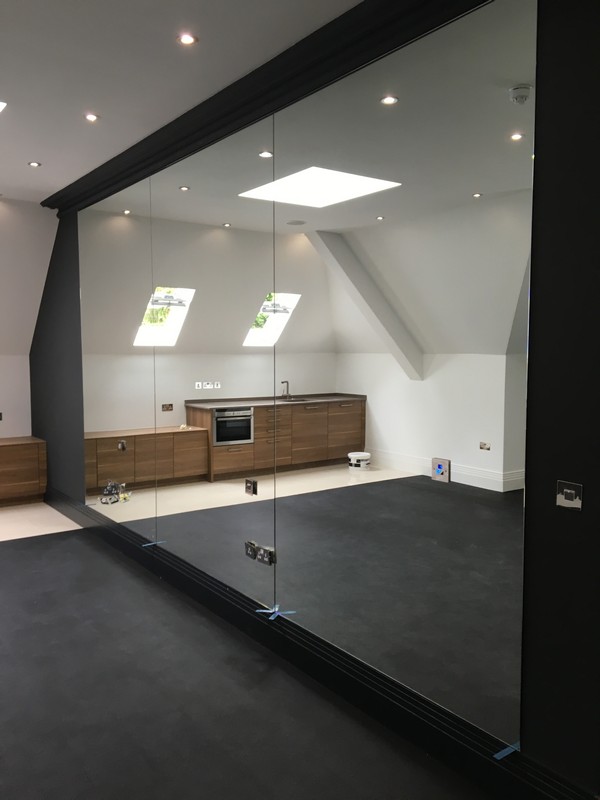 Frameless glass partition in loft conversion by Herne Hill glaziers