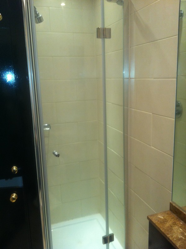 Frameless glass shower enclosure with chrome fittings in Herne Hill