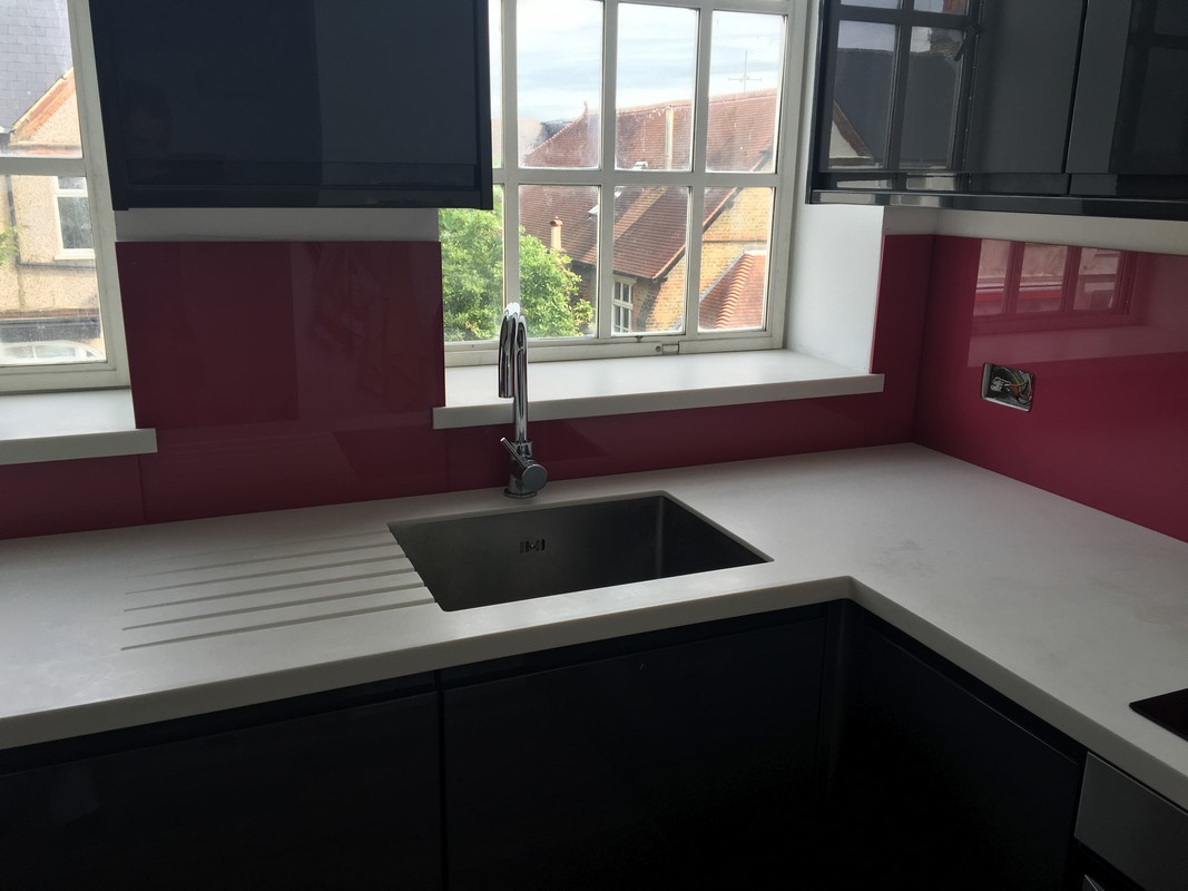 Deep plum coloured glass splashback in modern Herne Hill kitchen